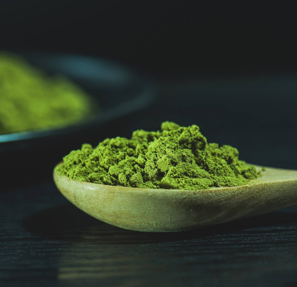 Fine Japanese matcha powder and a whisked bowl of green tea