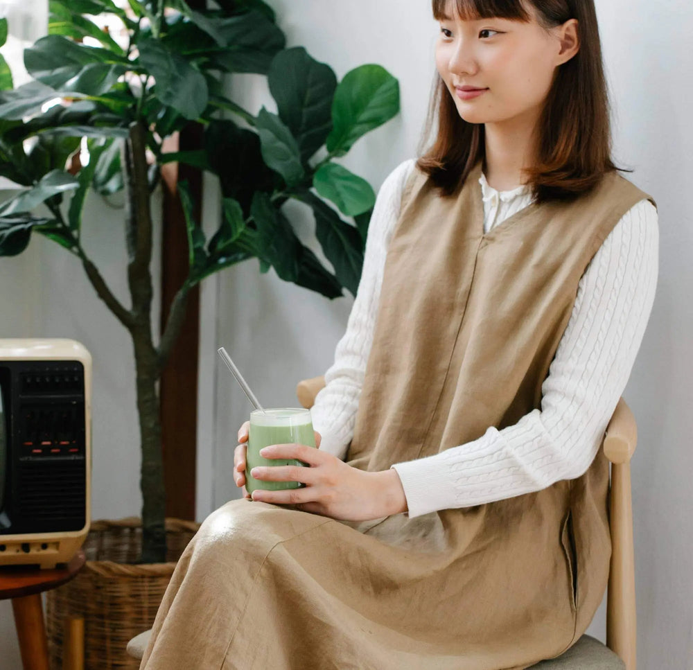 Whisked matcha in a ceramic bowl with green tea powder