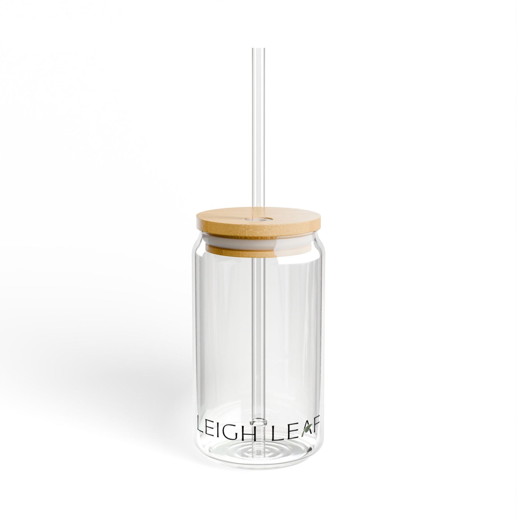 The Leigh Leaf Elegant 16oz Matcha Sipper Glass displayed upright with a bamboo lid and straw. A stylish choice for matcha glass sipper aficionados.